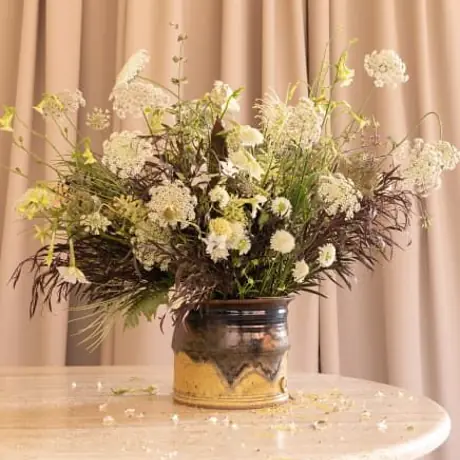 Interior styling detail with travertine table and dried blooms